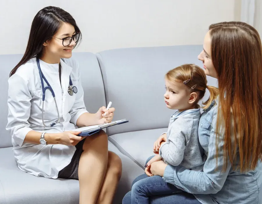 Pediatric Nurse Practitioner Smiling with Patient in Exam