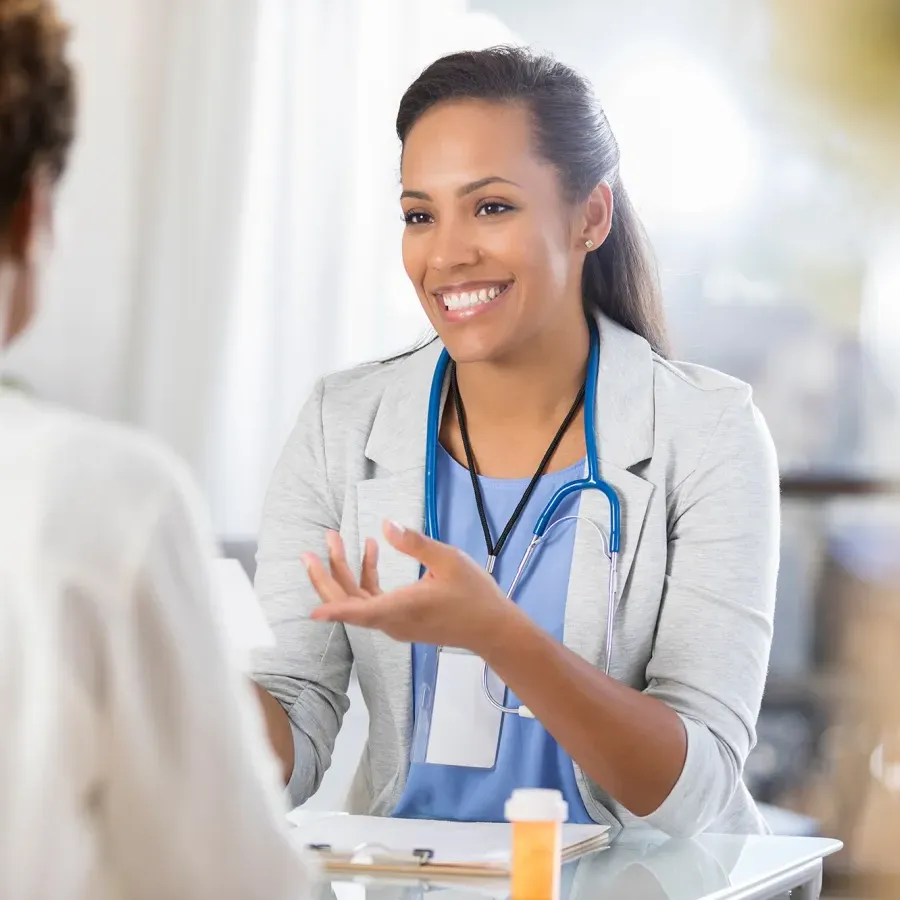 Public Health Nurse with Certificate Speaking with Patient During Appointment